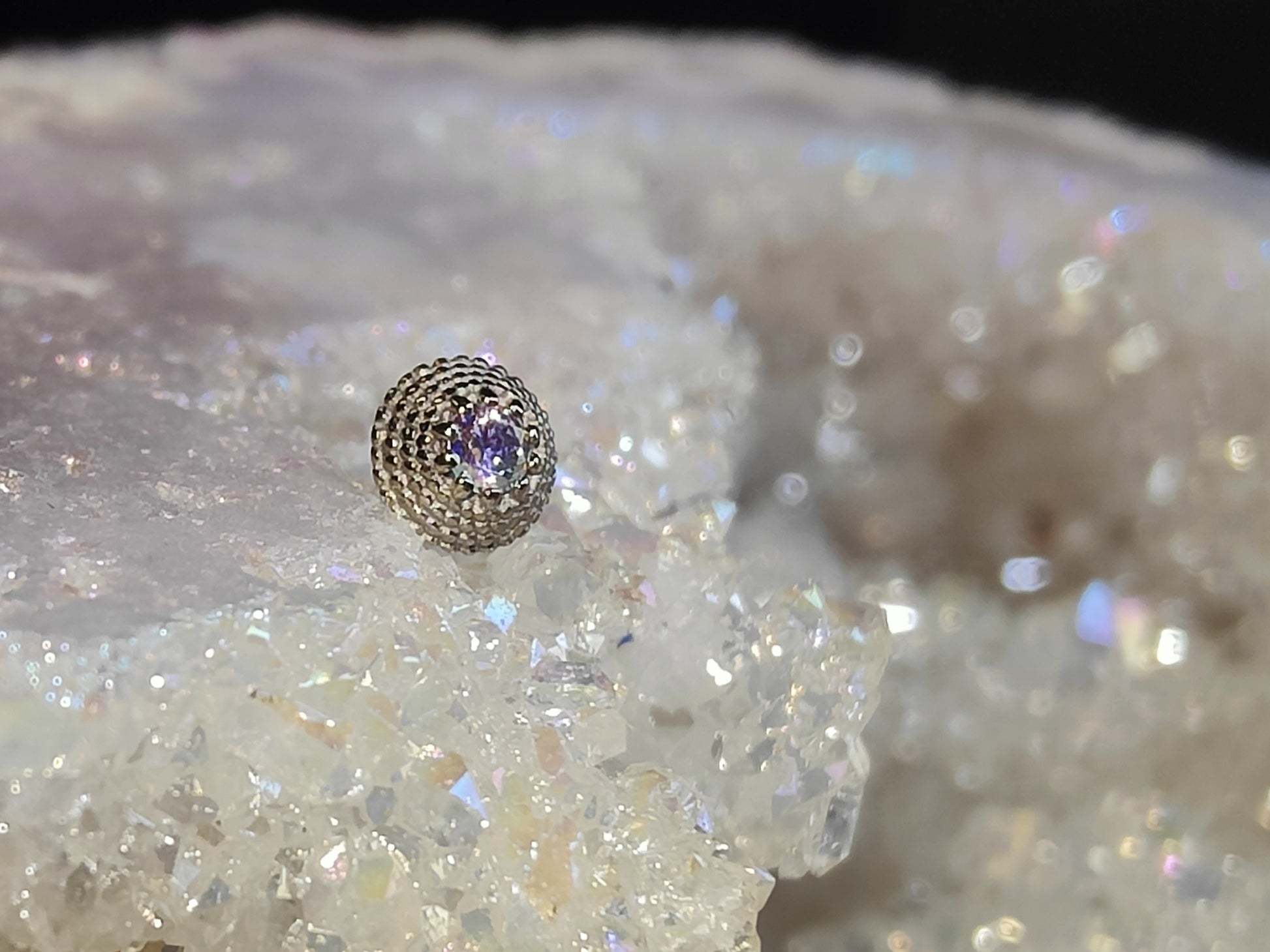 cricular solid white gold milligrain end with a small A B gem in the centre