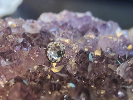 flat circular white gem end on an amethyst crystal