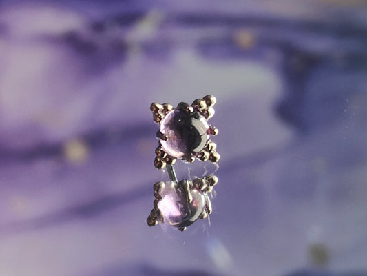 solid white gold beaded end with an amethyst centre stone