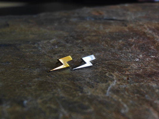 2 lightning bolt attatchments one in silver titanium and one in gold titanium